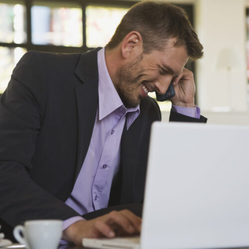 Business man in office laughing, portrait