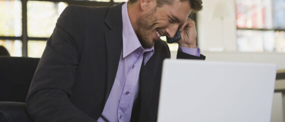Business man in office laughing, portrait
